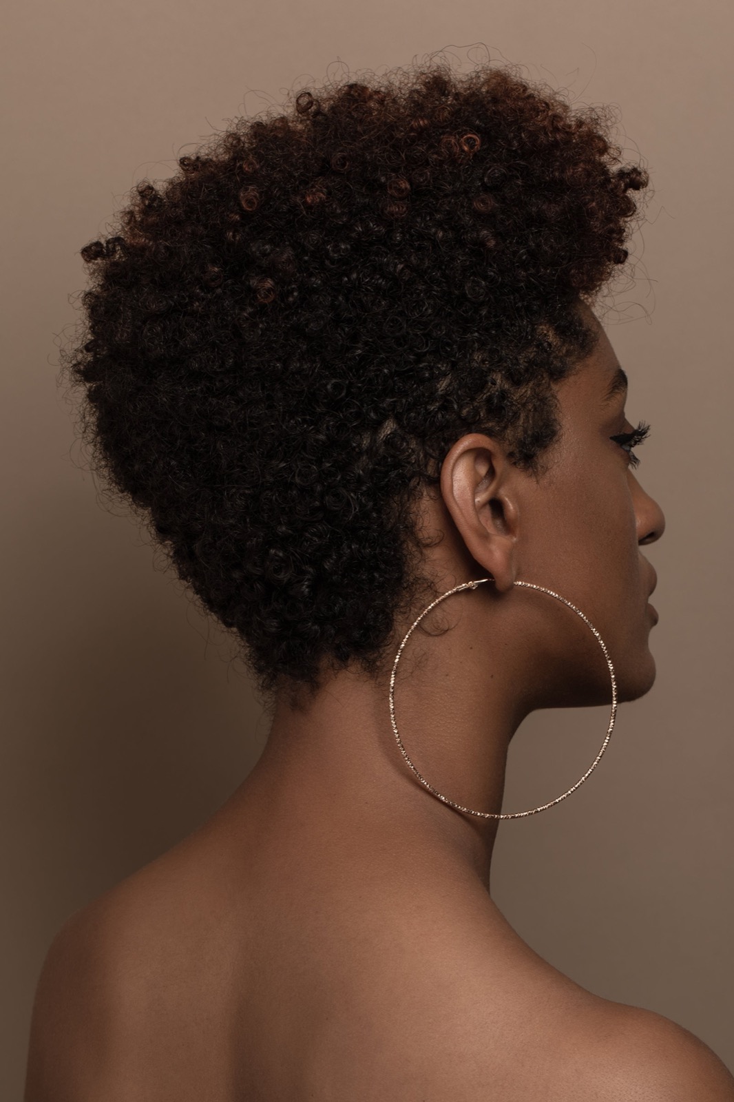 Beauty professional in a warm editorial portrait